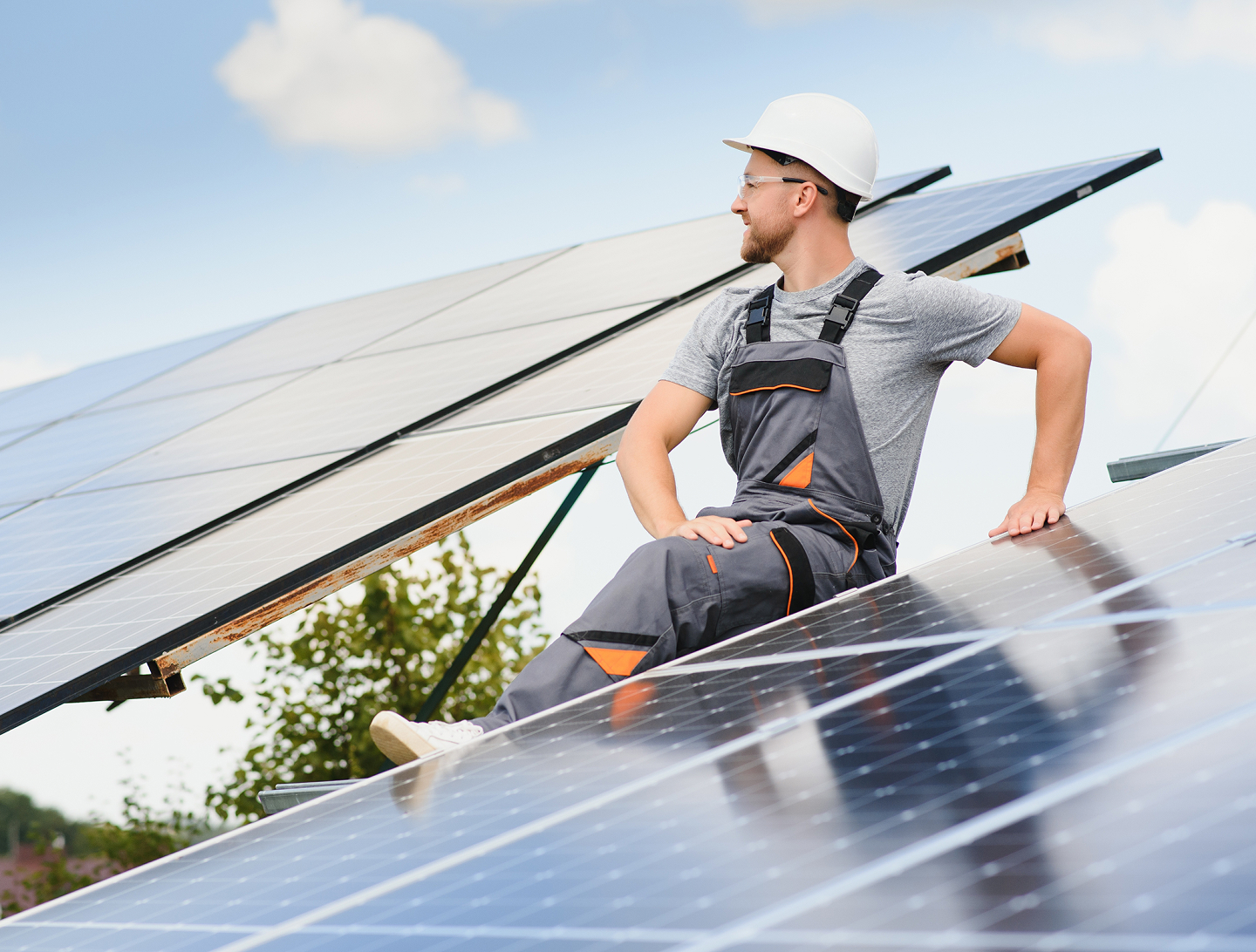 Solar installer working on a rooftop panel array